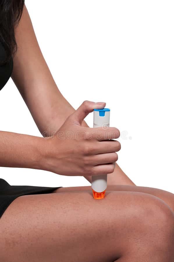 epipen being used on a leg to treat an allergy