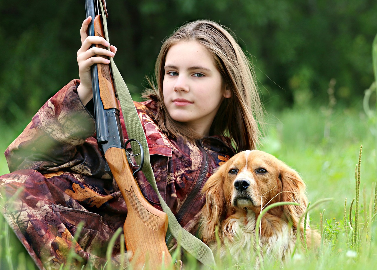 hunter, girl, dog resemble each other