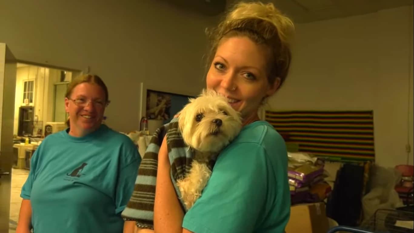 two women with a Maltese dog who survived the flood