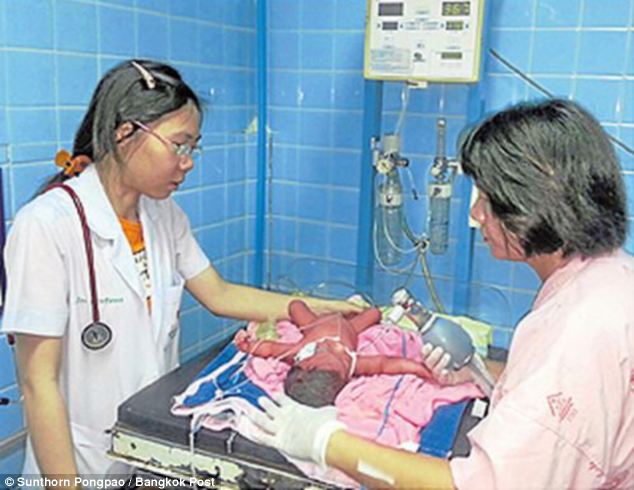 doctor, nurse, newborn baby in isolette in hospital