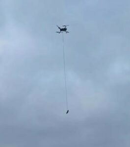 drone dangling sausages to rescue a dog