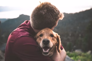 man hugging his dog who rescued whom?